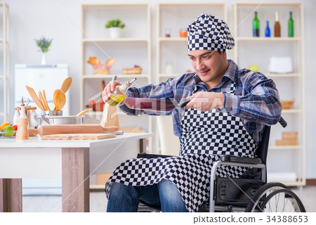 Disabled young husband frying at kitchen Disabled young husband frying at kitchen 34388653