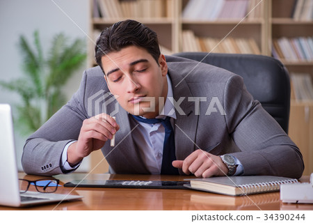 Drug addict businessman in the office 34390244