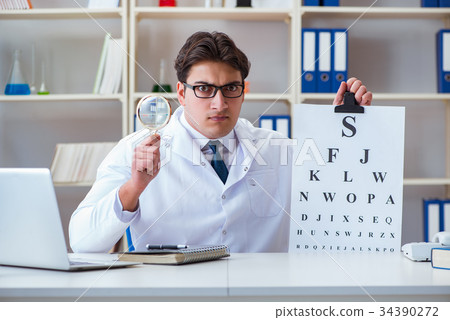 Doctor optician with letter chart conducting an 34390272