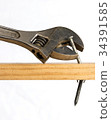 Adjustable wrench removing a nail 34391585