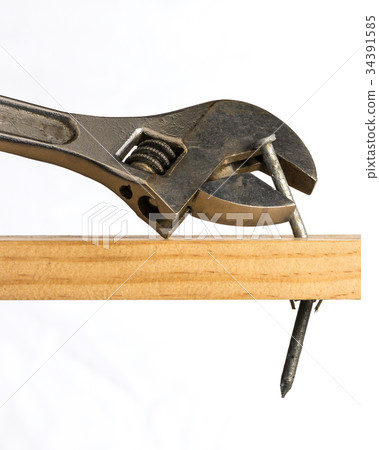 Adjustable wrench removing a nail 34391585