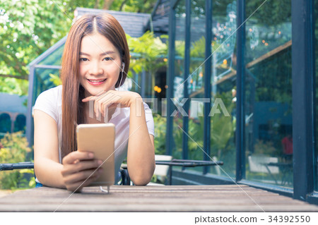 young happy asian woman looking smiling at camera 34392550