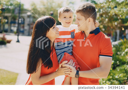 beautiful family in red walking down the street beautiful family in red walking down the street 34394141