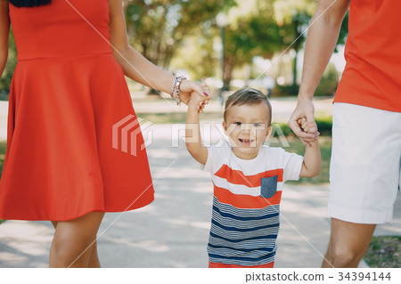 beautiful family in red walking down the street beautiful family in red walking down the street 34394144