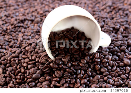 A cup of white coffee is on the coffee beans. A cup of white coffee is on the coffee beans. 34397016