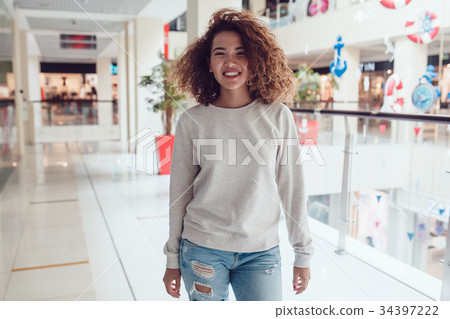 Curly haired girl with freckles in blank grey Curly haired girl with freckles in blank grey 34397222