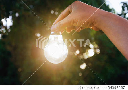 Idea hand holding light bulb concept solar 34397667