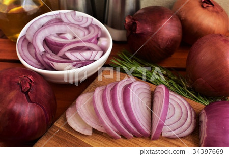 Red onion sliced  in a bowl and on cutting board. 34397669