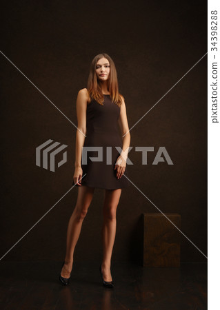 girl in short dress posing near wall  34398288
