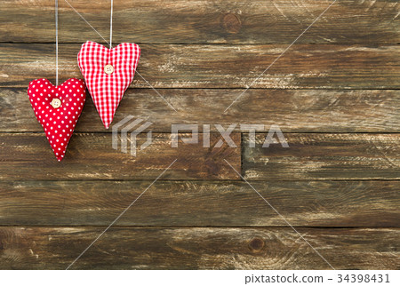 Red Hearts Hanging over Brown Wooden Background Red Hearts Hanging over Brown Wooden Background 34398431