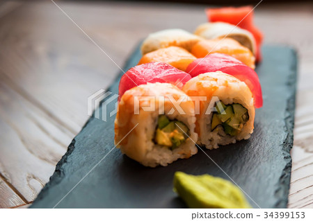 Rainbow sushi roll with wasabi on tray close up 34399153
