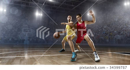 Basketball players on big professional arena 34399787
