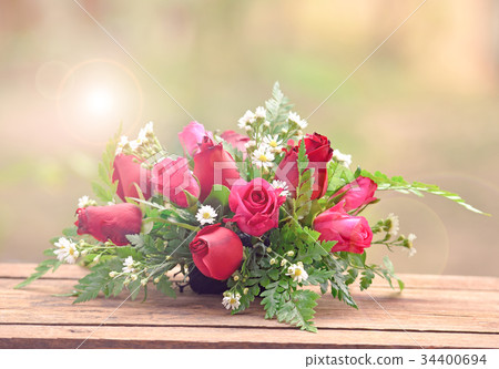 bouquet of roses on wooden table 34400694
