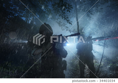 Special Forces soldiers in action. Elite squad moves through fog and smoke. 34401034