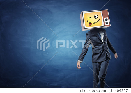 A strangely walking businessman wears a vintage TV 34404237