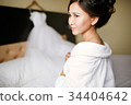 A bride in a white robe from the morning before 34404642