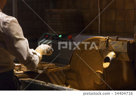 Machine processes and creat of chocolate, pouring Machine processes and creat of chocolate, pouring 34404716