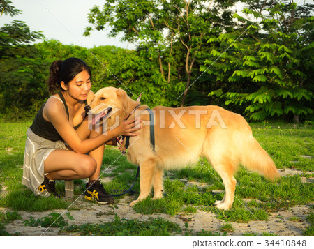 Golden retriever and Asian woman Golden retriever and Asian woman 34410848