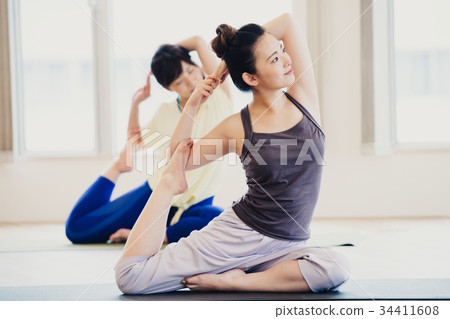 Young woman doing yoga in yoga studio Young woman doing yoga in yoga studio 34411608