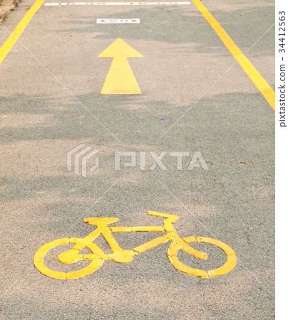 yellow arrows and bicycle sign path on the road yellow arrows and bicycle sign path on the road 34412563