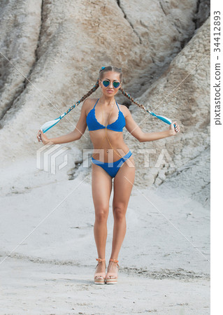 Beautiful girl in a bikini on the beach Beautiful girl in a bikini on the beach 34412893