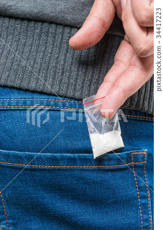 bag with drug dose in pocket close-up drug dealer bag with drug dose in pocket close-up drug dealer 34417223
