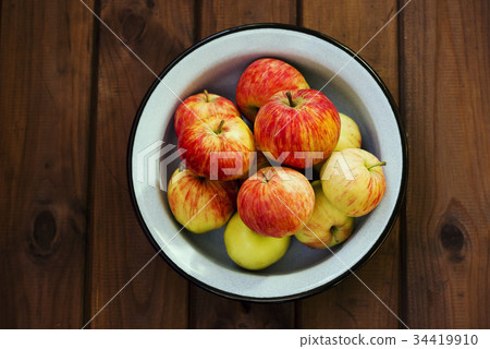 Seasonal garden red apples in metal bowl  34419910