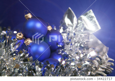 Blue New Year balls and tinsel on a blue backgroun Blue New Year balls and tinsel on a blue backgroun 34422717