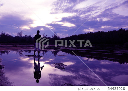 Mirror of man, purple sky reflection to the water 34423928