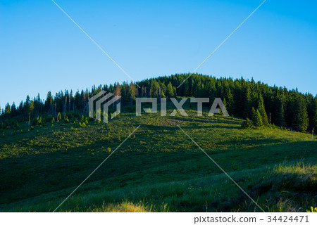 Blue sky and green hills.  34424471