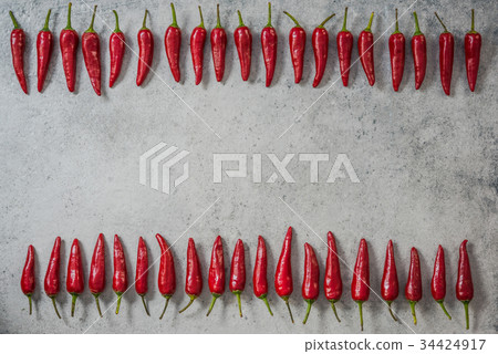 Red chili peppers in row, food background Red chili peppers in row, food background 34424917