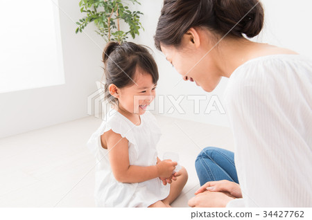 Mom wiping the hand of a child 34427762