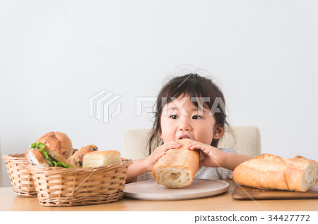 A child holding a bread A child holding a bread 34427772