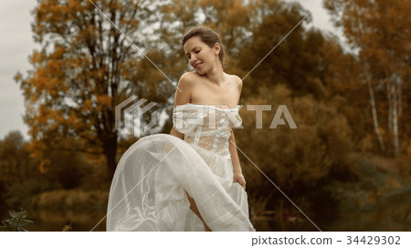Beautiful girl in a white dress and autumn Beautiful girl in a white dress and autumn 34429302