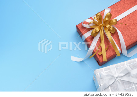 Red and white gift boxes on blue background 34429553