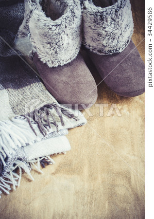 Warm home clothes. Woolen plaid and home slippers. 34429586