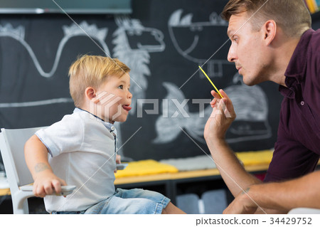 Cute little boy at speechtherapist session. Cute little boy at speechtherapist session. 34429752