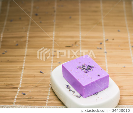Bar of natural lavandah soap on white soap dish Bar of natural lavandah soap on white soap dish 34430010