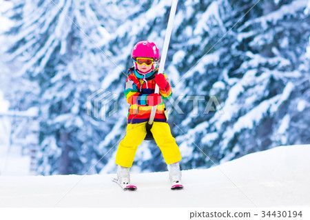 Child on ski lift snow sport school in mountains 34430194