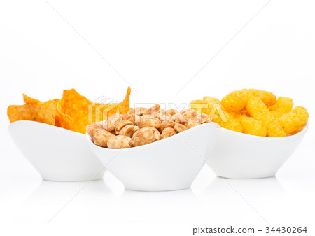 Cheese corn snacks and nachos with salty peanuts Cheese corn snacks and nachos with salty peanuts 34430264