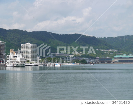 Lake Biwa at the end of summer. Tourist boat and yacht harbor and mountains. 34431420