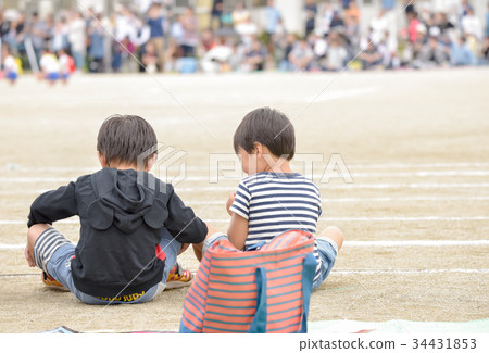 A boy looking at the athletic meeting 34431853