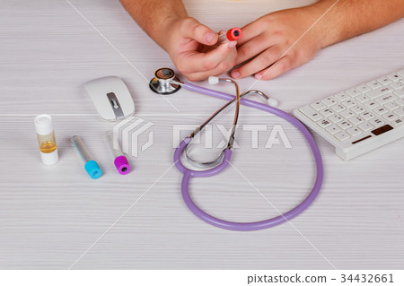 Doctor hand holding the medical blood tube Doctor hand holding the medical blood tube 34432661