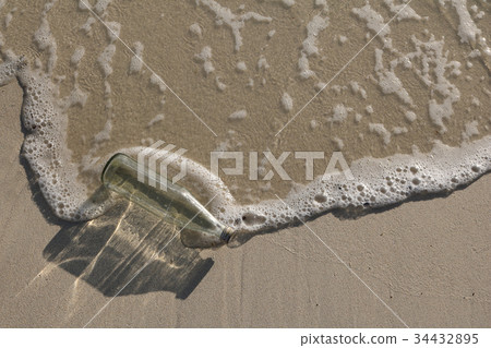 Glass bottle trash on the beach. 34432895