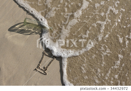 Glass bottle trash on the beac 34432972