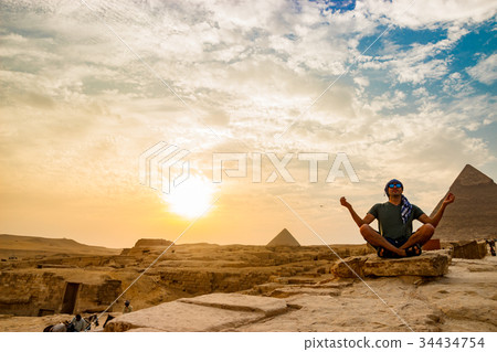 Meditation near the pyramids in Cairo, Egypt Meditation near the pyramids in Cairo, Egypt 34434754