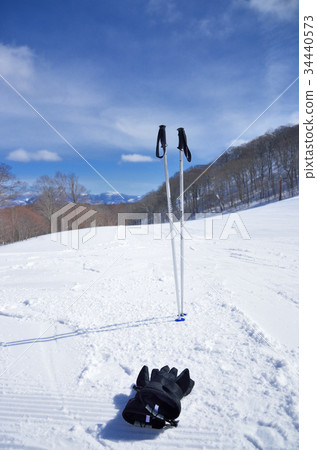 Winter sunny ski area and ski equipment 34440573