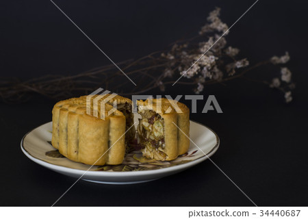 Moon cakes filled with mixed nuts black background Moon cakes filled with mixed nuts black background 34440687