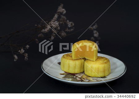 Moon cakes with custard filling black backgroun 34440692