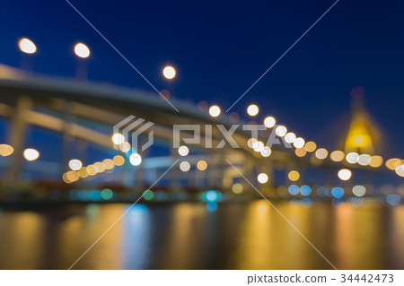 Night blurred light city bridge water front 34442473